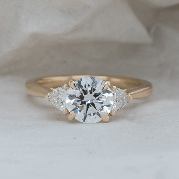 Aquila Round Brilliant and Trilliant Cut Engagement Ring Yellow Gold | Noah James Jewellery.