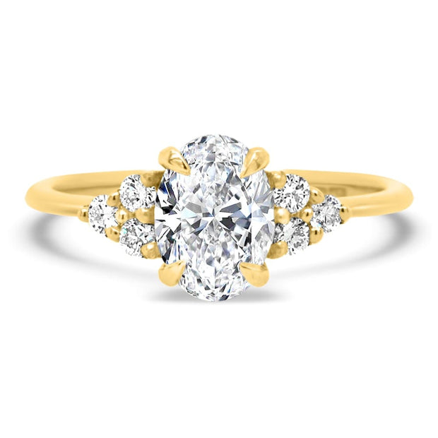 Margot Oval and Round Brilliant Cut Trefoil Shoulder Engagement Ring Yellow Gold | Noah James Jewellery.